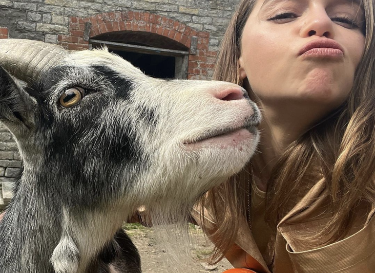 Emilia Clarke MBE with rescue goat, Bertie