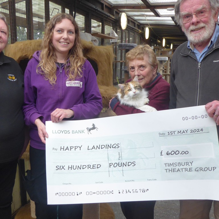 Timsbury Theatre Group representatives present Happy Landings with cheque for £600